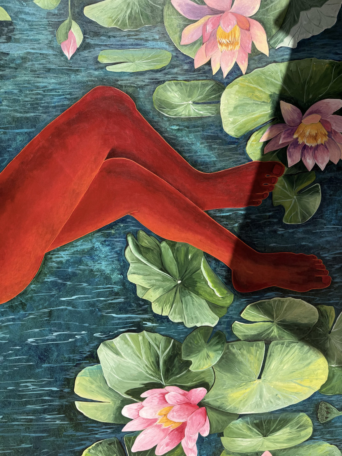 Sirena — detail: red legs stretched across the water among lily pads and pink water lilies